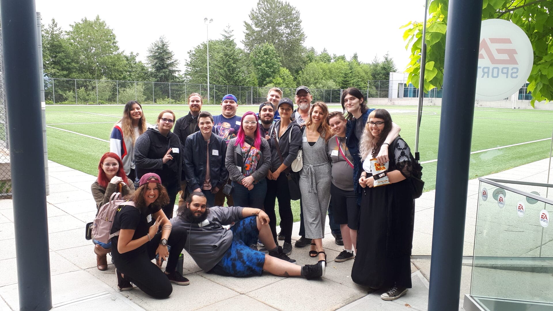 Animation students from College for Arts and Technology on an industry field trip in the Vancouver region of B.C. Image shows students smiling at the entrance of EA Sports.