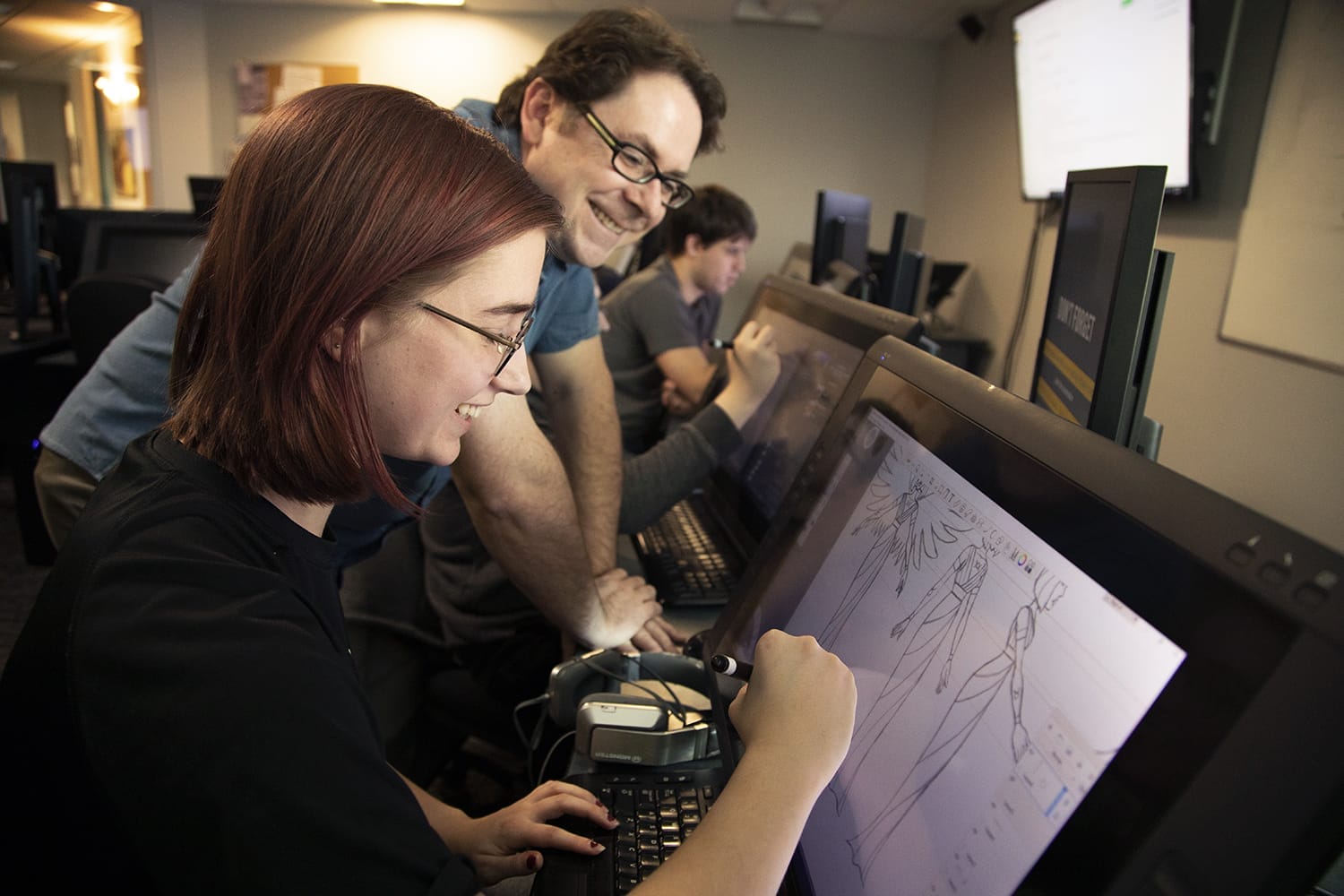Image showing Animation Department Head Sean Ridgway coaching a student through a digital drawing activity in a Centiq lab classroom at College for Arts and Technology.