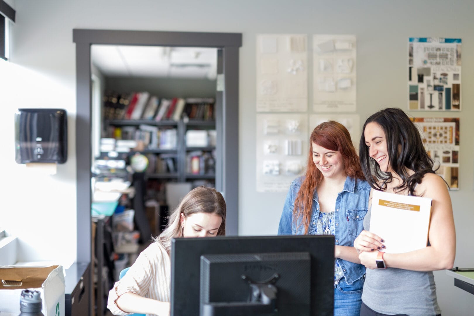 Interior Design students from College for Arts and Technology discussing a project in their design classroom.  