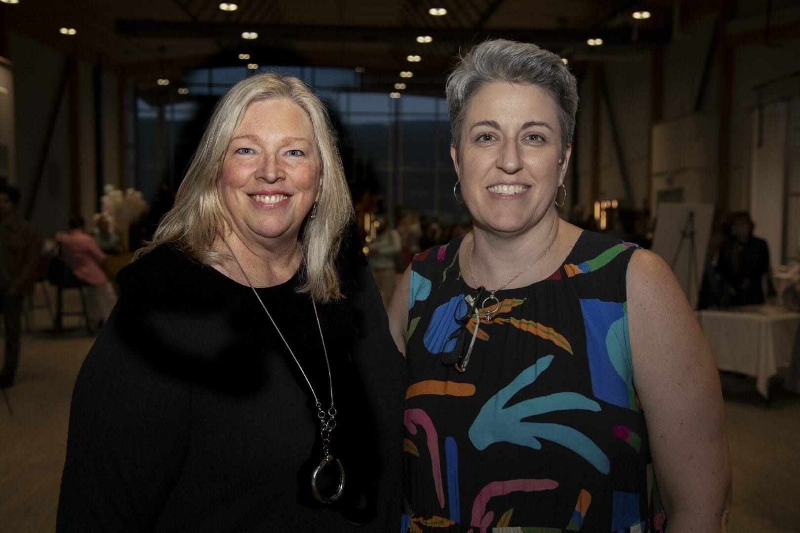 Interior Design Department Head smiles for a photograph with graduate, Glori Duncan.